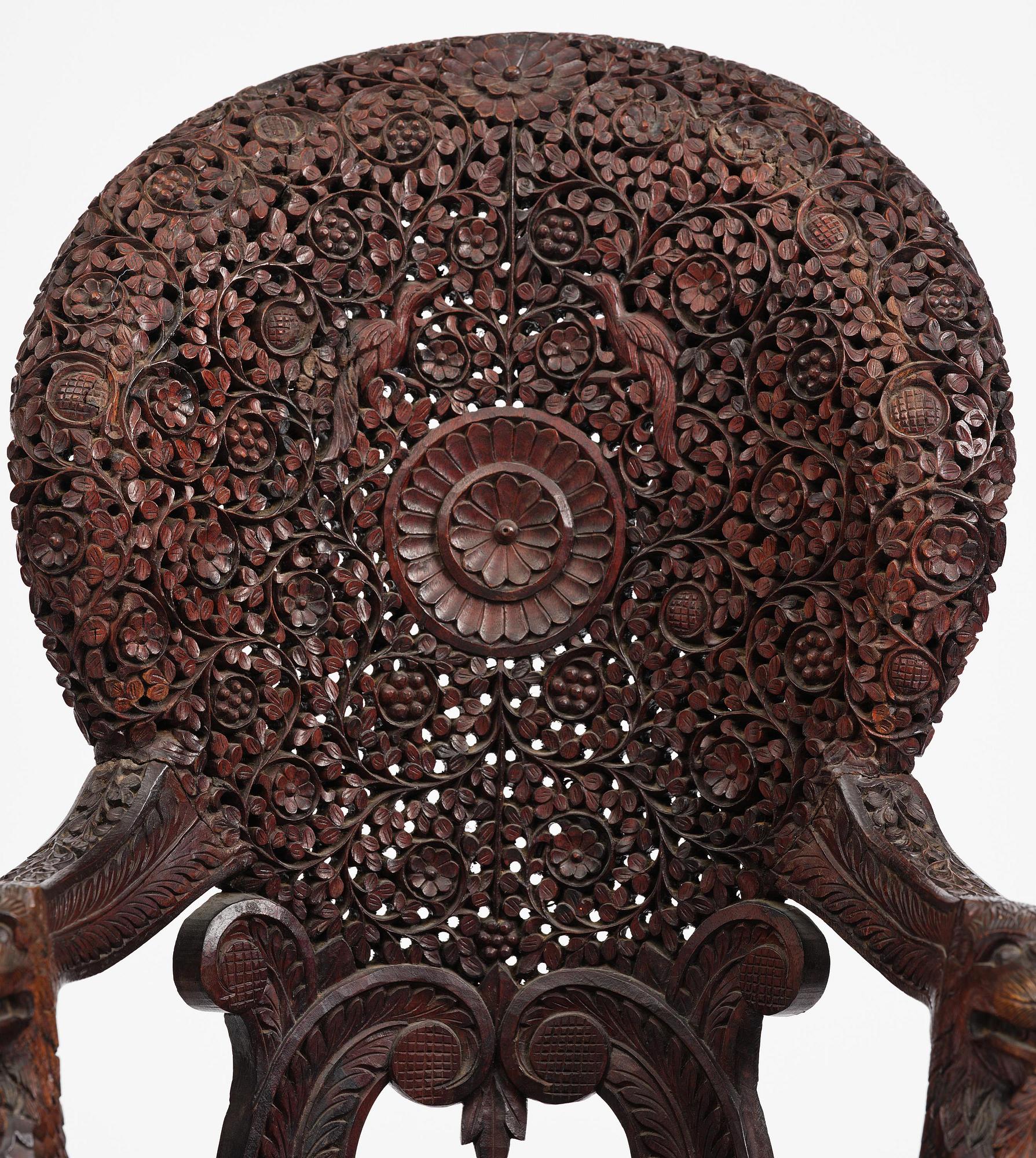 A pair of carved 'blackwood' armchairs, Bombay presidency, British Raj, circa 1880.