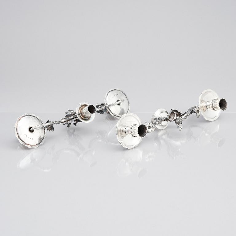 A pair of Swedish 18 century silver candelabras, mark of Lars Åkerblom Gävle 1775, arms by Christian Kullberg.