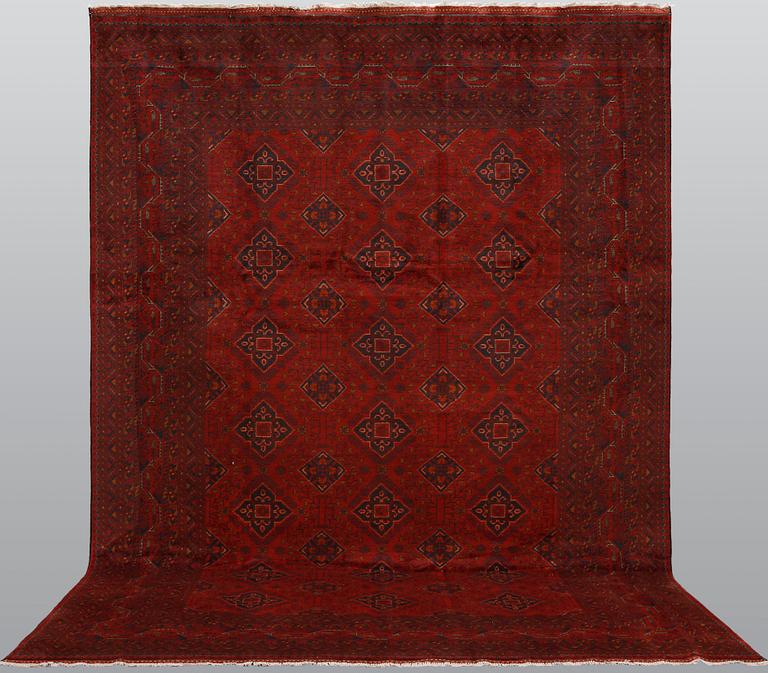 An Afghan carpet, 343 x 243 cm.