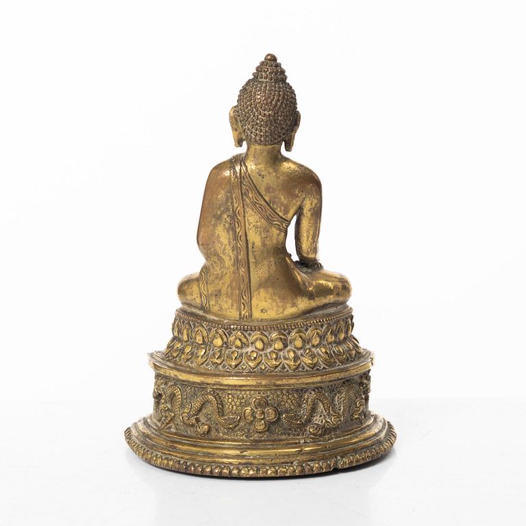A gilt bronze figure of a Buddha, Nepal, 20th century.
