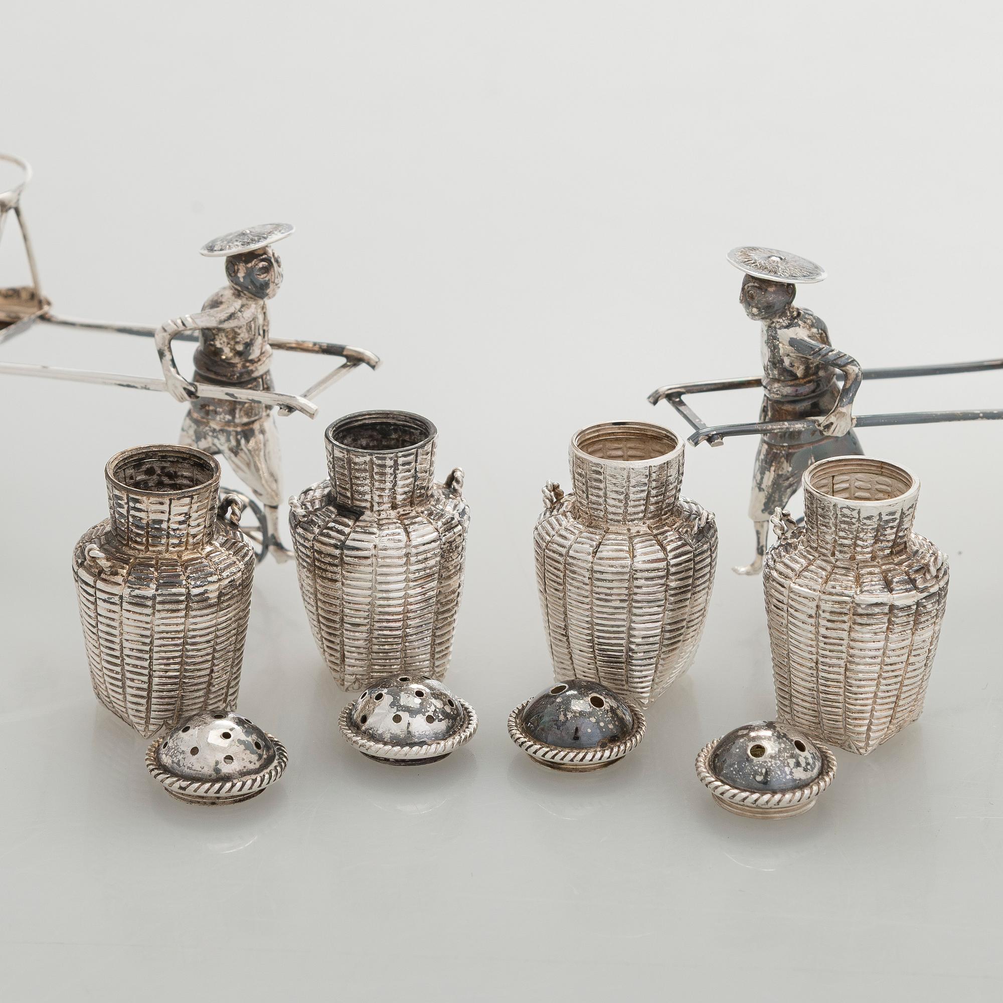 Four shakers in a pair of miniature rickshaws, sterling silver, maker's mark of Wai Kee, Hong Kong.