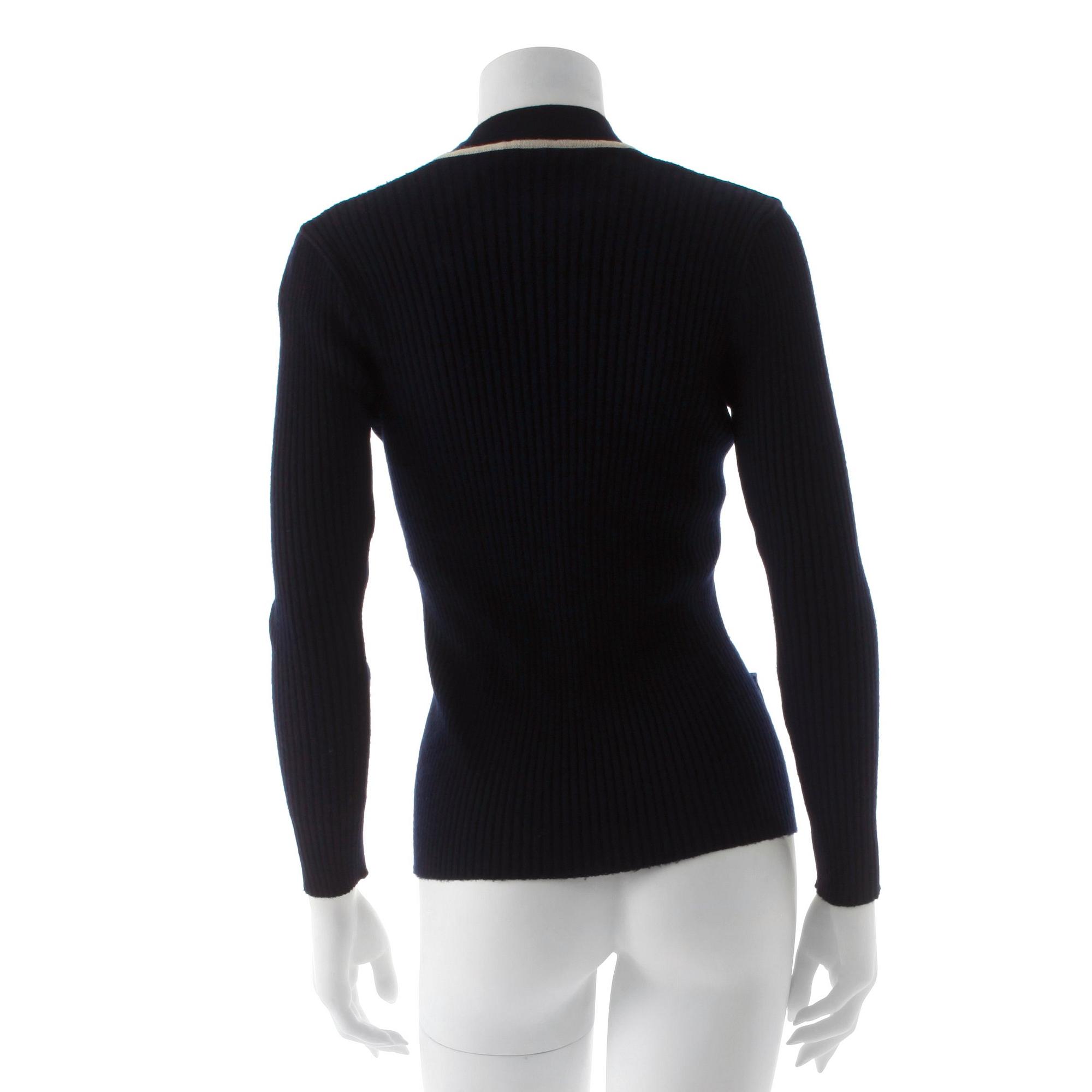 CÉLINE, a navy blue cardigan.