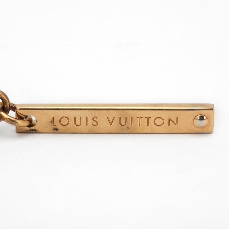 LOUIS VUITTON, a brass bag charm.