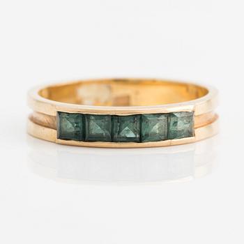 Ring with square-cut green stones.