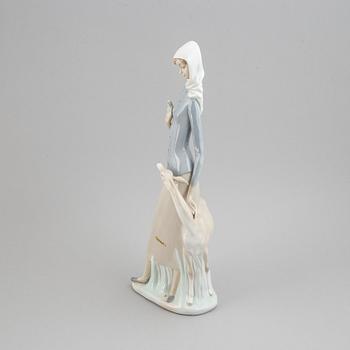 A Lladro porcelain figure of a lady with a dog, Spain, 20th Century.