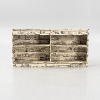 A bookcase decorated in prints from Dahlbergs Suecia antiqua et hodierna, mid 20th century.