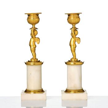 A pair of late Gustavian white marble and ormula candlesticks.