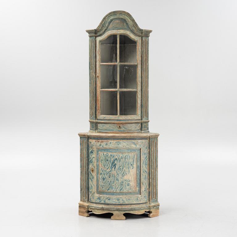 A marbeled corner cabinet, 18th Century.