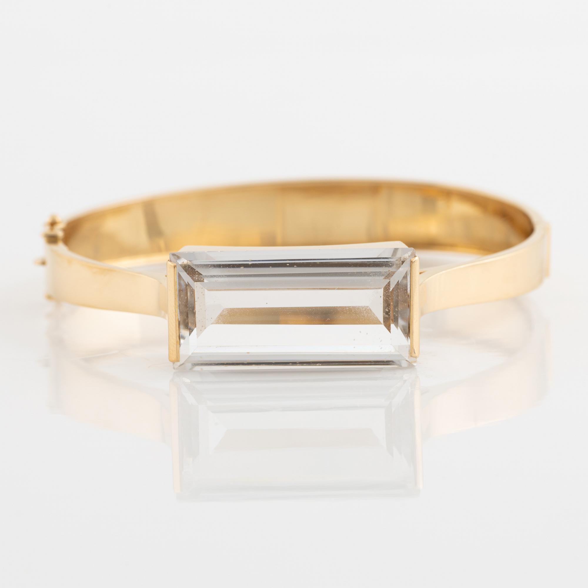 An 18K gold bangle set with synthetic spinel.