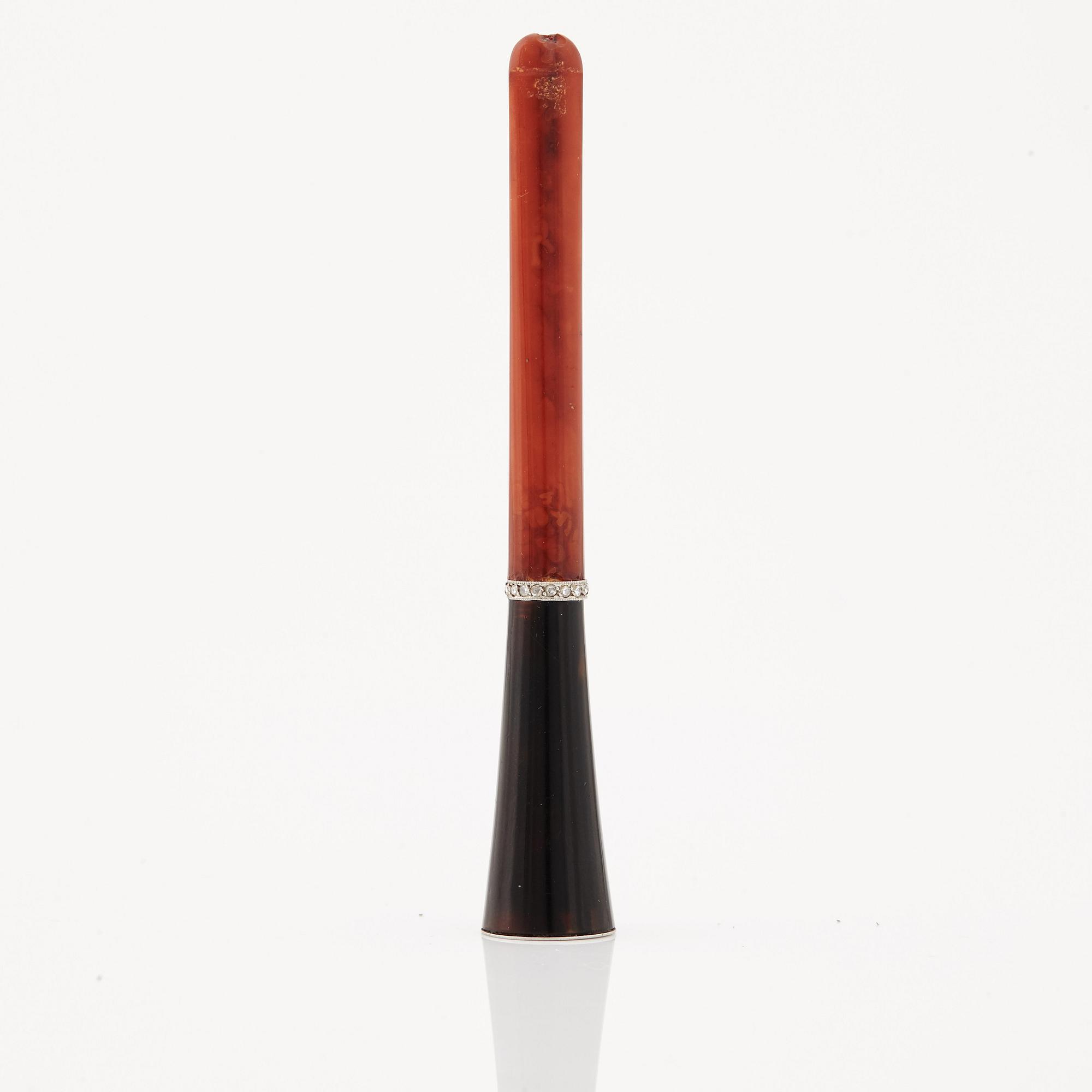 A 1920's cigarette holder of tortoiseshell and meerschaum decorated with rose-cut diamonds.