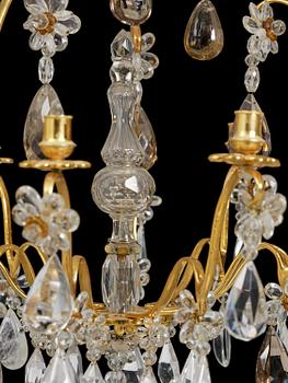A near pair of Franch Louis-XV-style nine-branch gilt bronze and rock crystal chandeliers, later part 19th century.