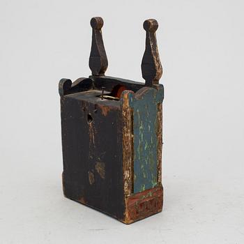 A carved and painted folk art pocket watch case dated 1774.