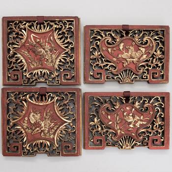 A set of four Chinese gilt and painted wooden decorations.