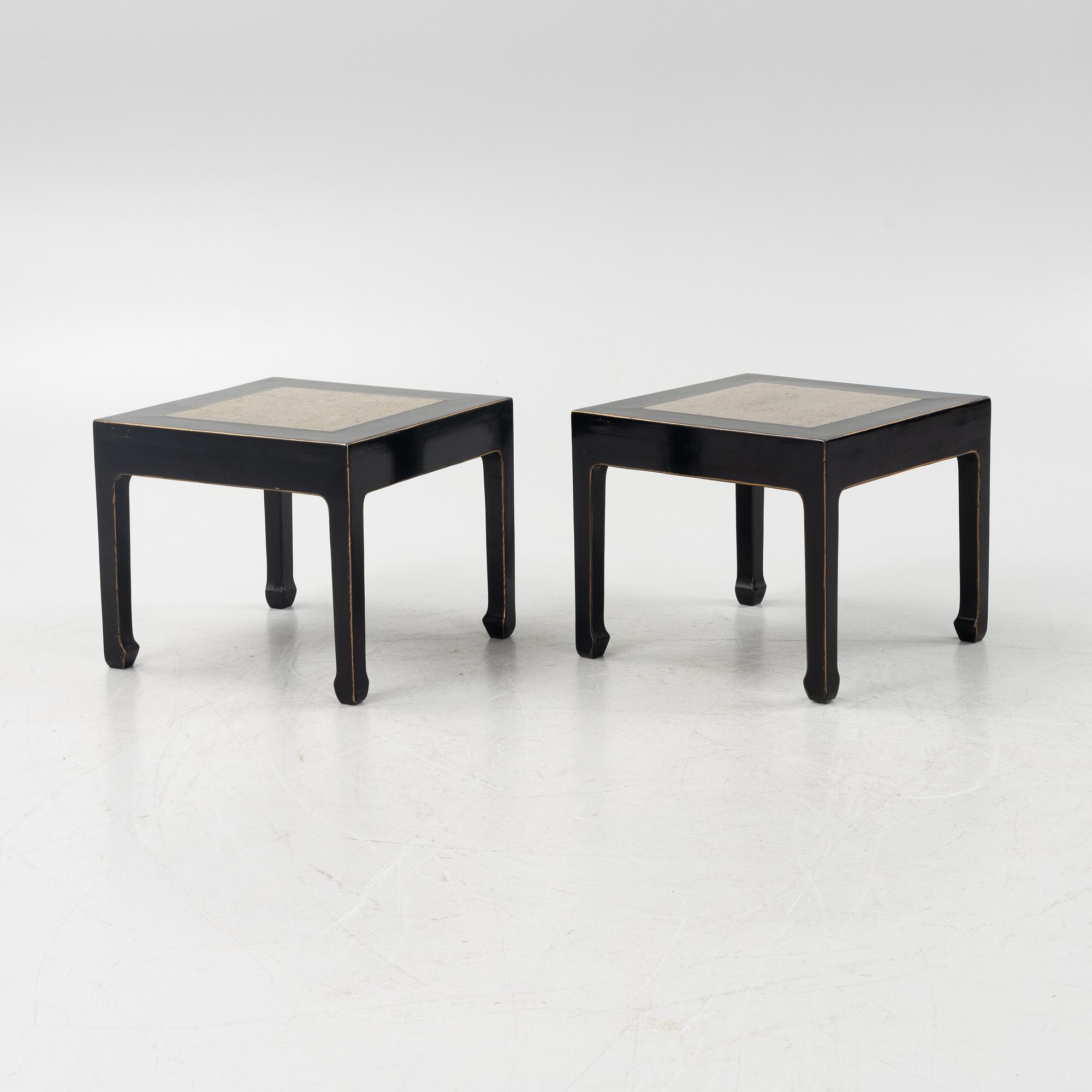 A pair of blac painted side tables with stone tops.
