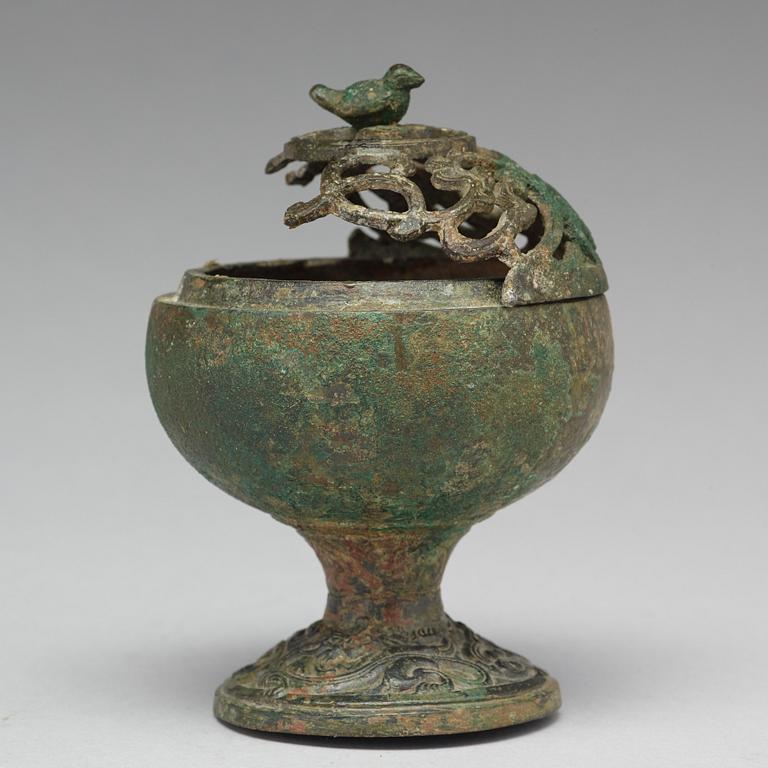 A group of five bronze objects, some Han dynasty (206 BC - 220 AD).