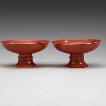 A pair of red glazed tazzas, Qing dynasty with Qianlong sealmark in underglaze blue.