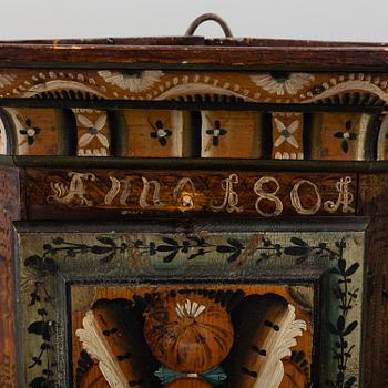 A 19th century corner cabinet.