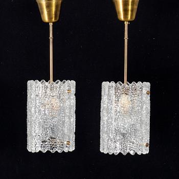 A pair of 20th century brass and glass ceiling lamps by Carl Fagerlund for Orrefors.