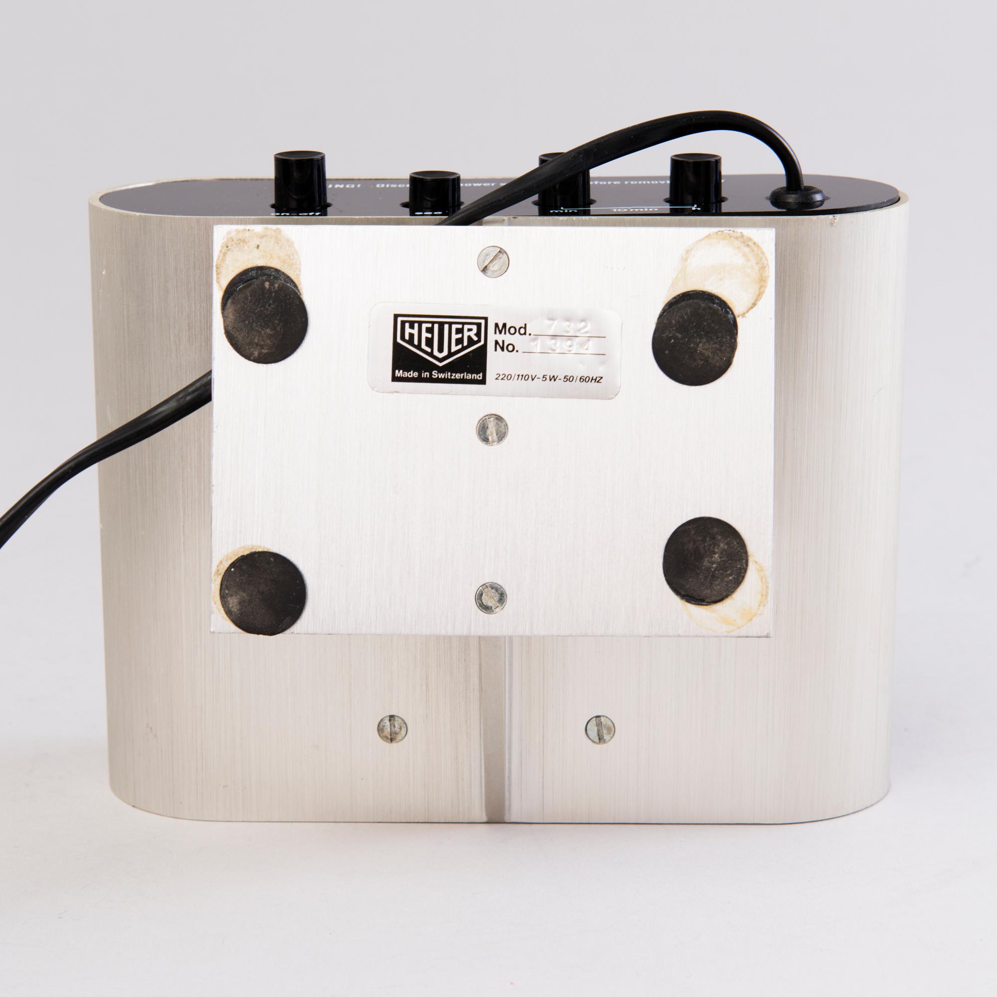 A 1970s digital Quartz TAG HEUER desk clock, brushed aluminium.