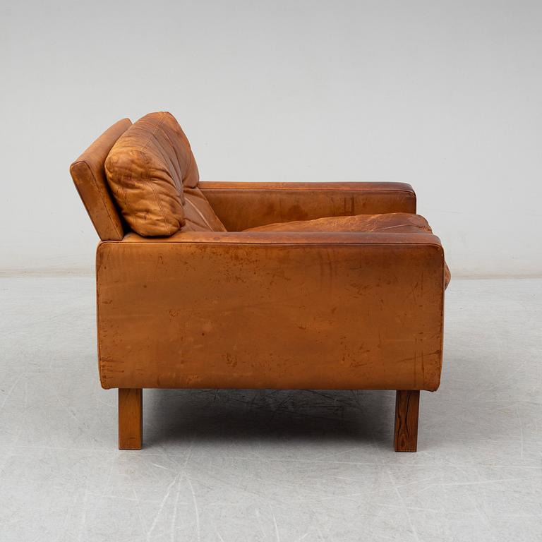 A 1960's/1970's leather covered easy chair with rosewood legs.