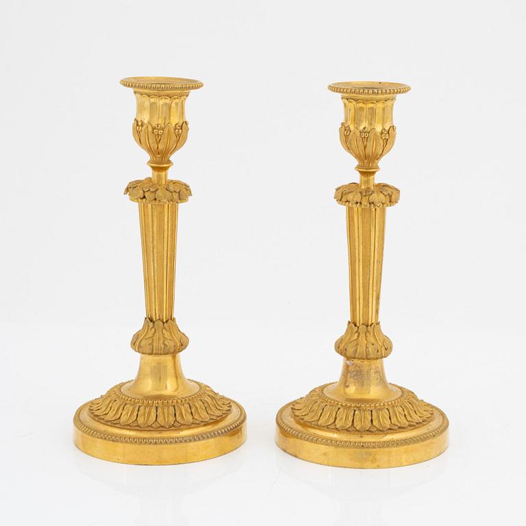 A pair of gilded bronze candelsticks, 19th Century.