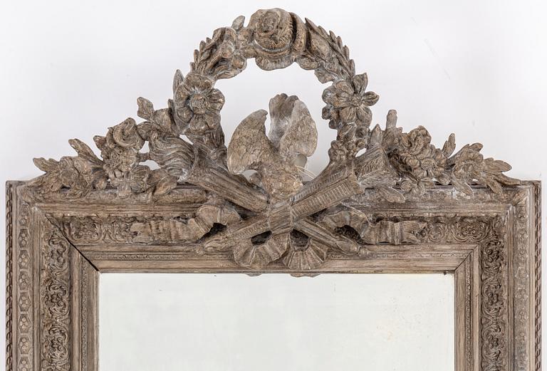 A carved wooden framed mirror, circa 1900.