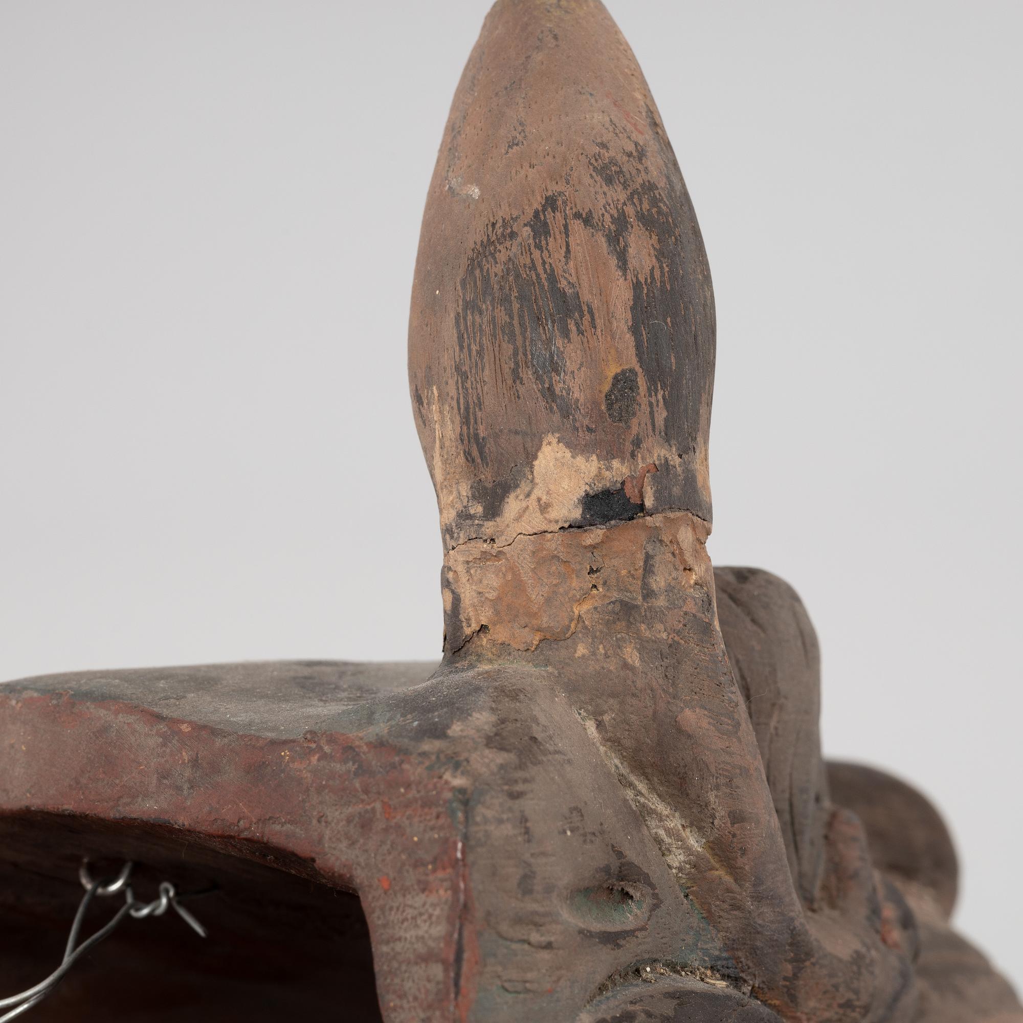 Four Tibetan/South East Asian wooden decorations, 20th century.