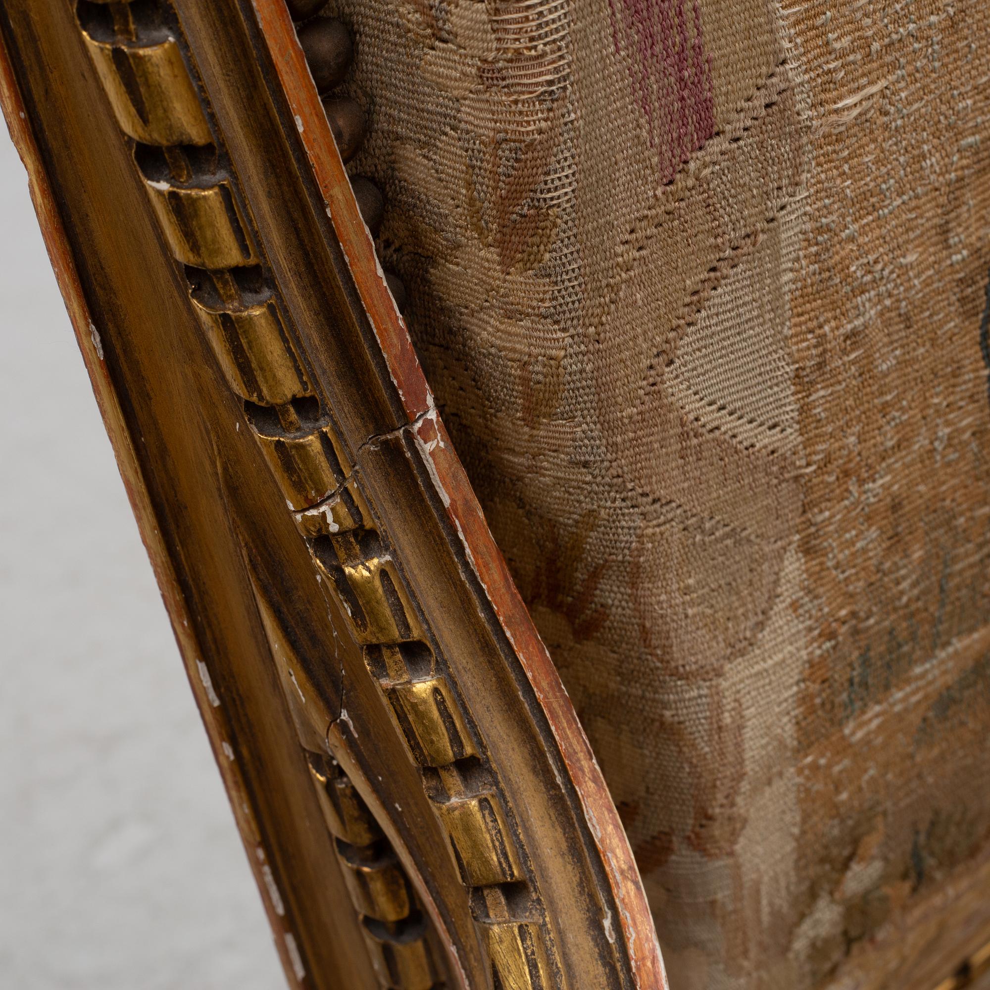 A pair of Louis XVI-style armchairs, late 19th century with 18th century fabric.