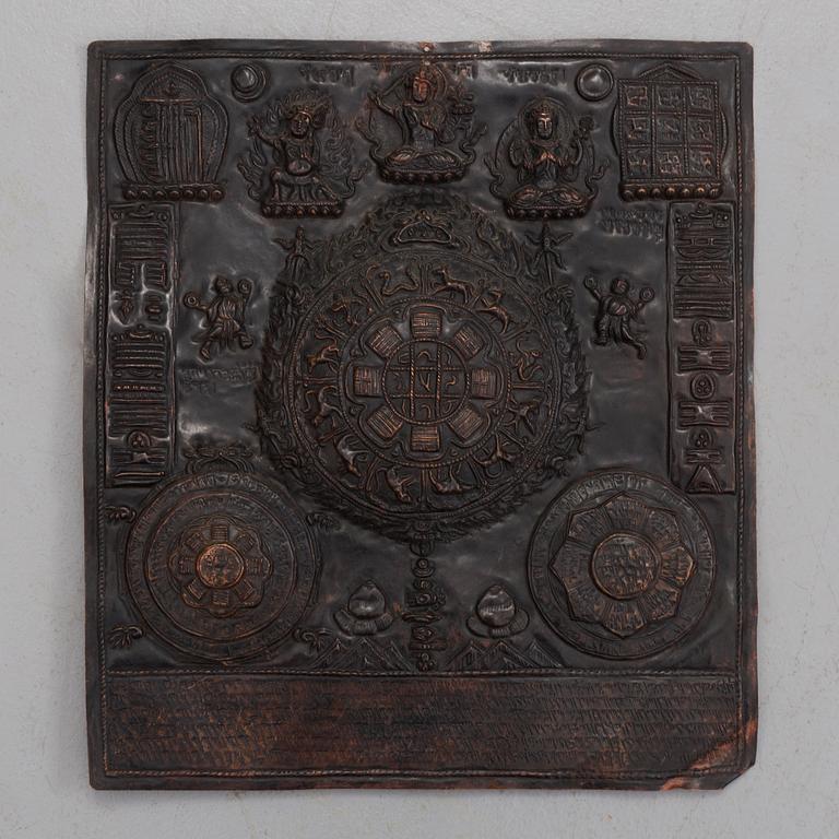 A Tibetan copper relief, 20th century.