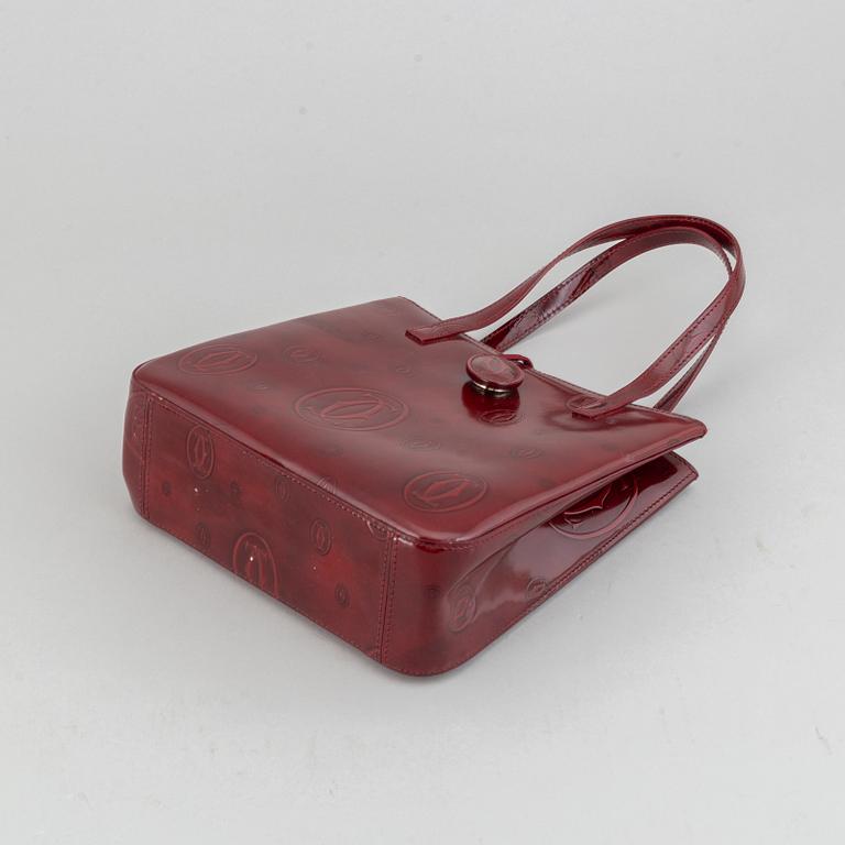 Cartier, a burgundy patent leather handbag and wallet.