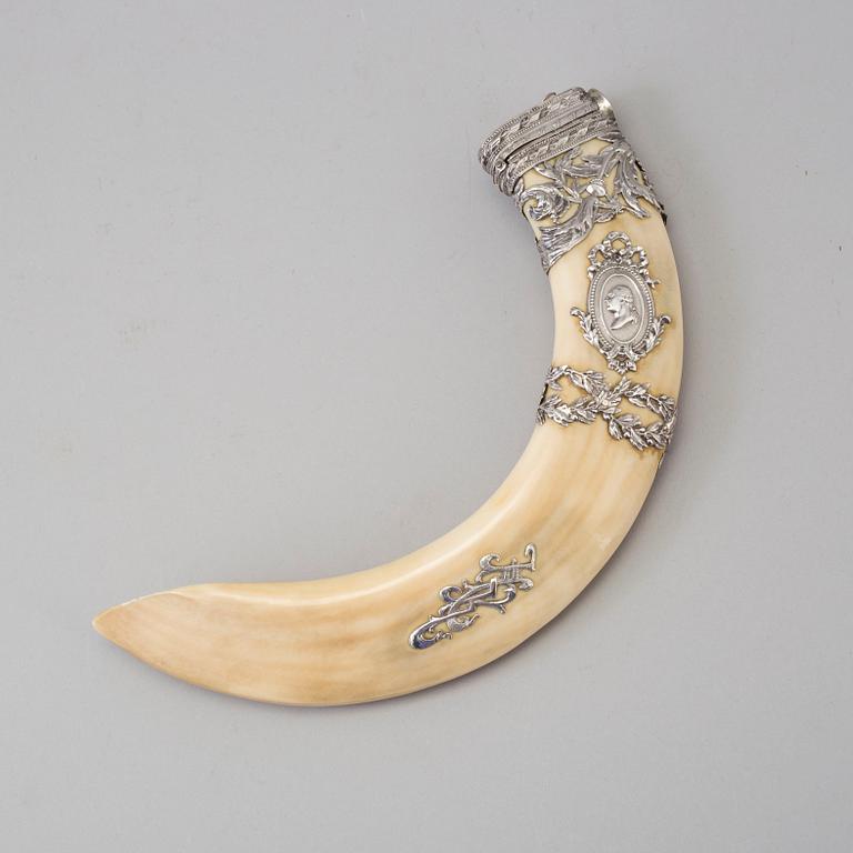 An early 20th century cigar cutter made of a wildboars tusk with silvermountings.