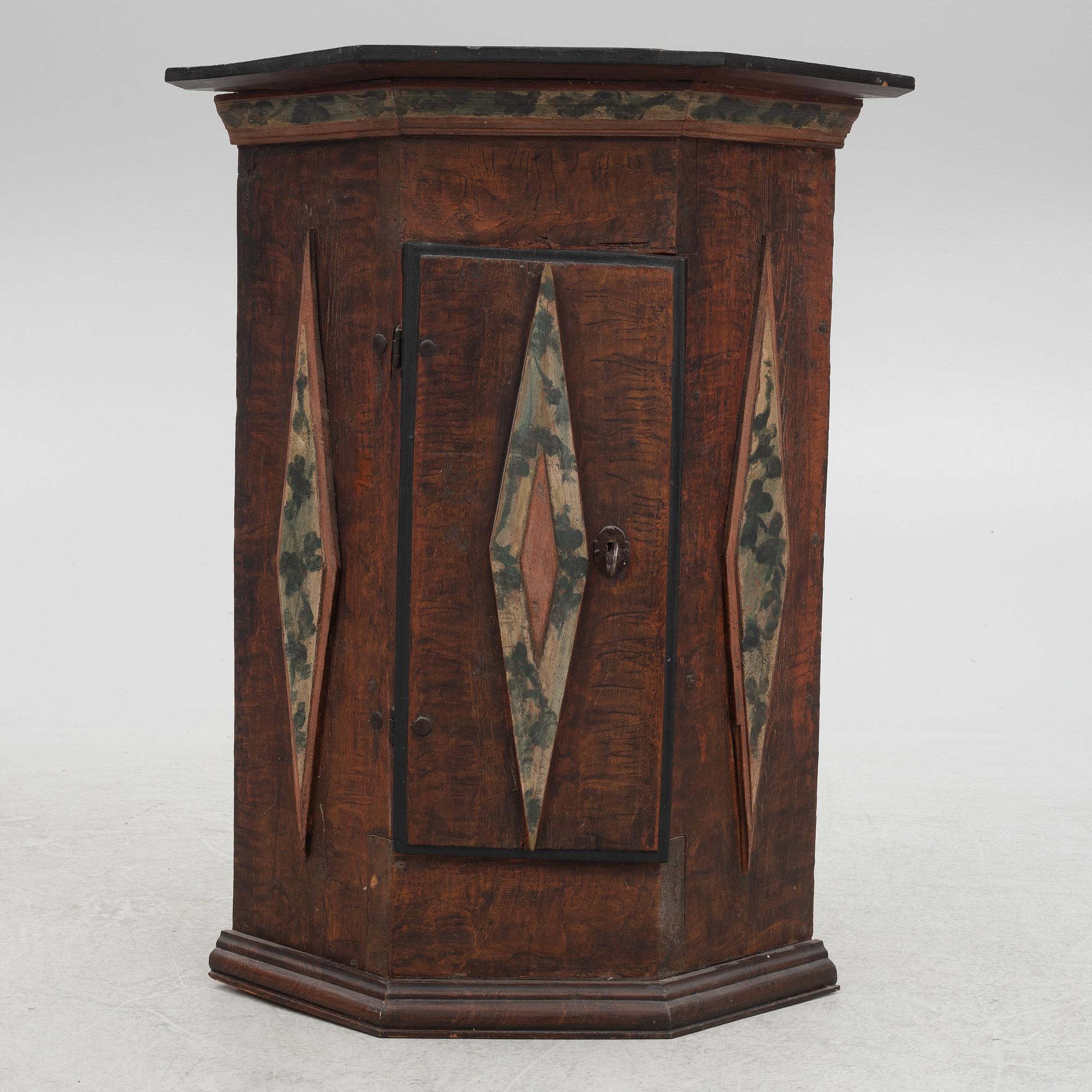 A corner cabinet, 18th Century.