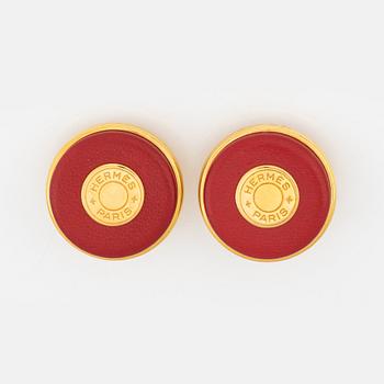 Hermès, a pair of gold tone metal and leather clip-on earrings.