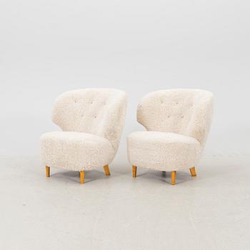 A pair of Scandinavian Modern 1940s cheepskin armchairs.