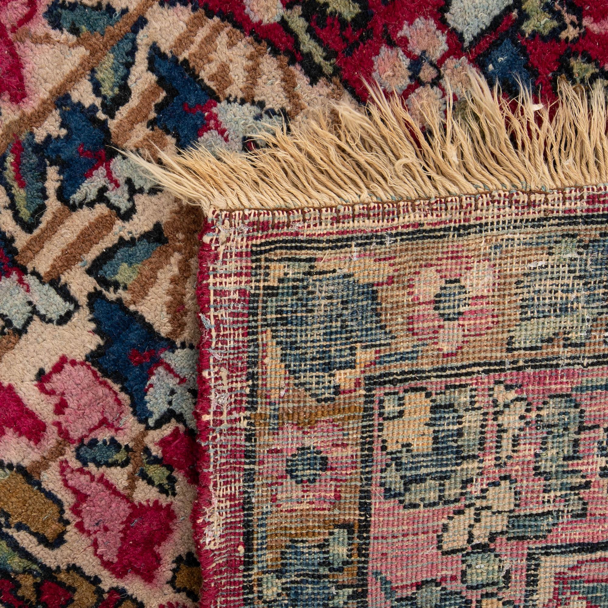 A semi-antique Kirman carpet, c. 396 x 261 cm.