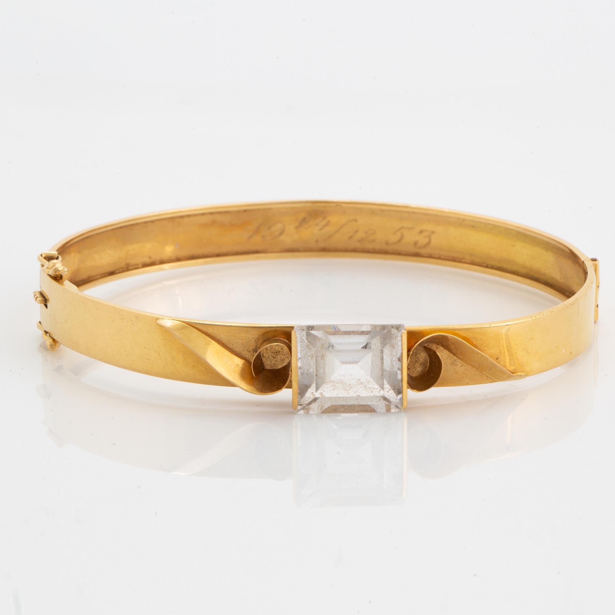 18K gold bangle and white synthetic stones.