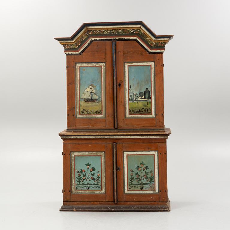 A Swedish polychrome.-painted cabinet, presumably from Halland, dated 1805.