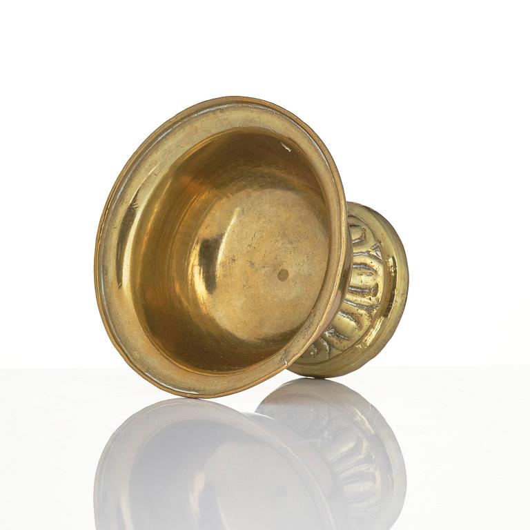 A bronze deity and a brass sacrificial bowl, Tibet, circa 1900.