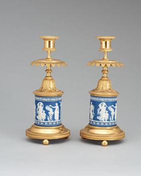 A pair of Victorian Wedgewood and gilt bronze candlesticks.