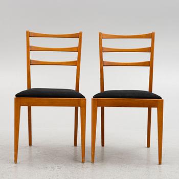 A dining table with four chairs, mid 20th century.