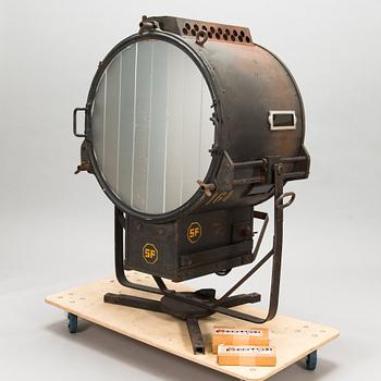 A film industry carbon arc spotlight with two boxes Kino-carbon sticks, + and -.
