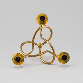 JOSEF FRANK, ljusstake, mässing ”Vänskapsknuten”, Firma Svenskt Tenn, 1900-tal.