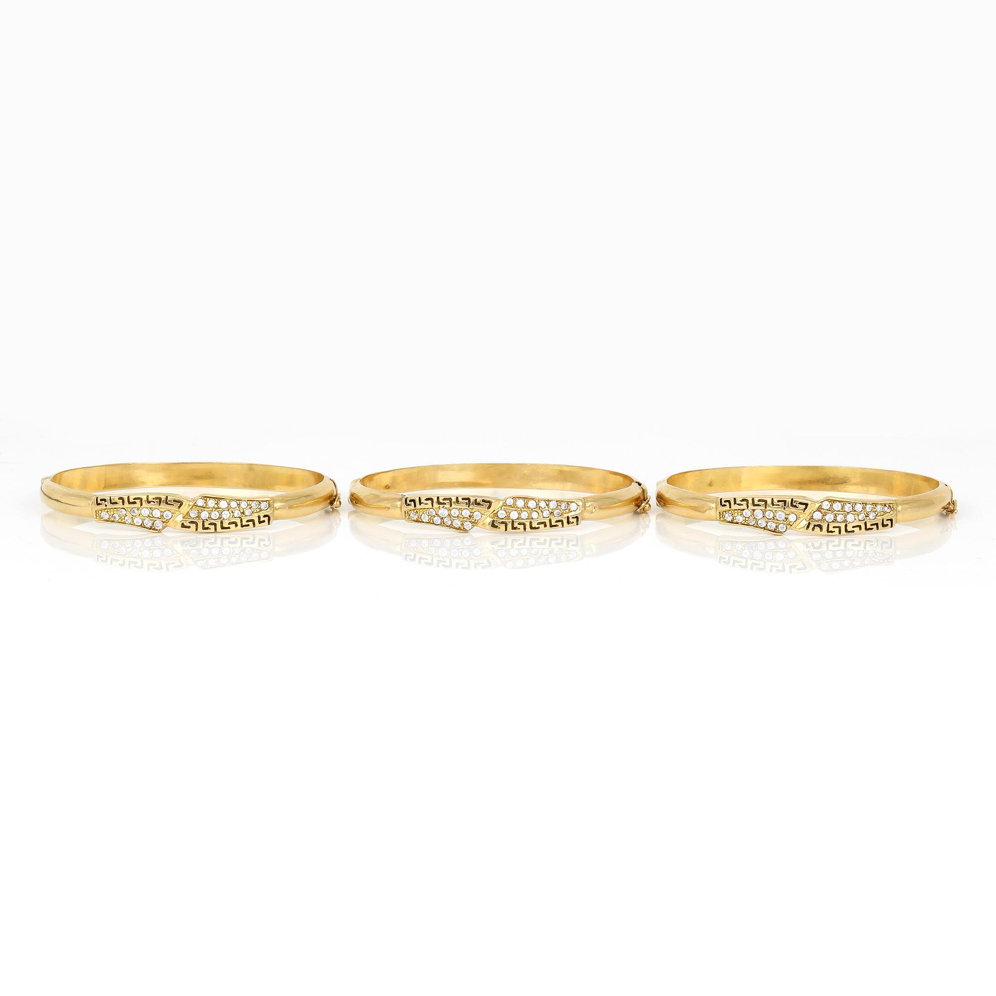 ARMRINGAR, 3 st, 18K guld med små vita stenar, sannolikt Frankrike. Total vikt ca 32 g.