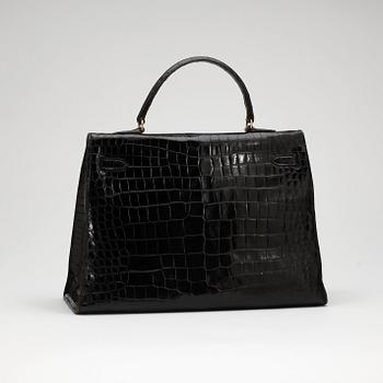 HERMÈS, a black crocodile "Kelly 35" bag from the 1960s.