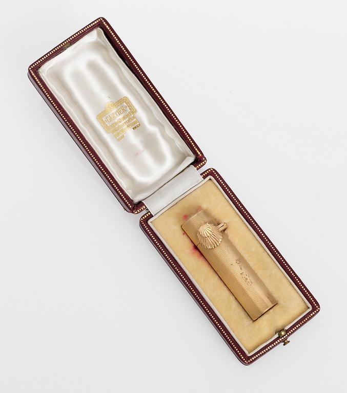 A Castier goldplated lipstick case.