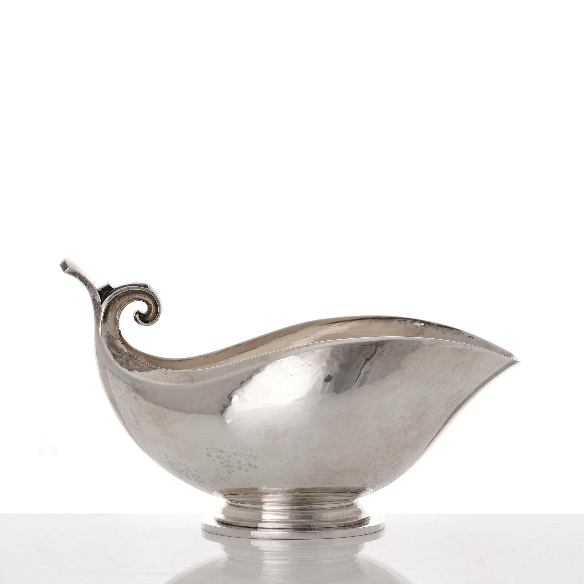 Georg Jensen, a sterling silver sauceboat and ladle, Copenhagen 1925-1945, design nr 98 and 141.