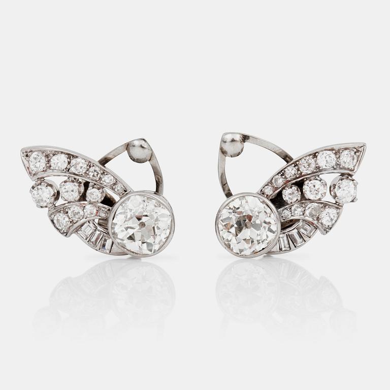 A pair of old-cut diamond earrings. Total carat weight of diamonds circa 5.00 cts. The large diamonds circa 2 cts each.