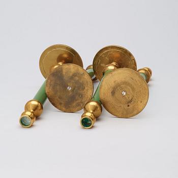 A set of four Svenskt Tenn brass and green lacquered candlesticks.