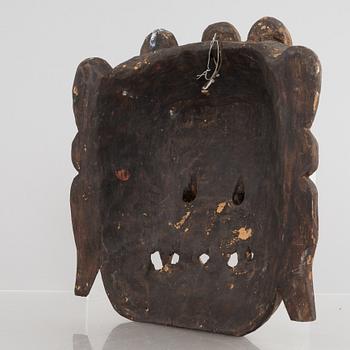 Four Tibetan/South East Asian wooden decorations, 20th century.