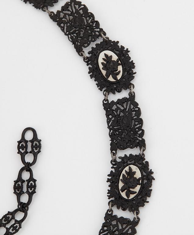 A Berlin steel and iron parure comprising a necklace, two bracelets and a brooch.
